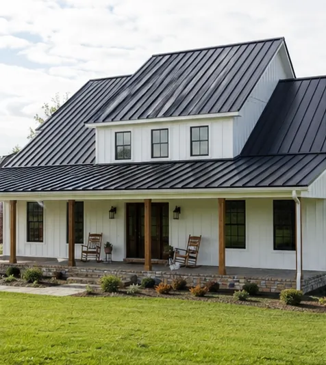 A standing-seam metal roof on a white farmhouse